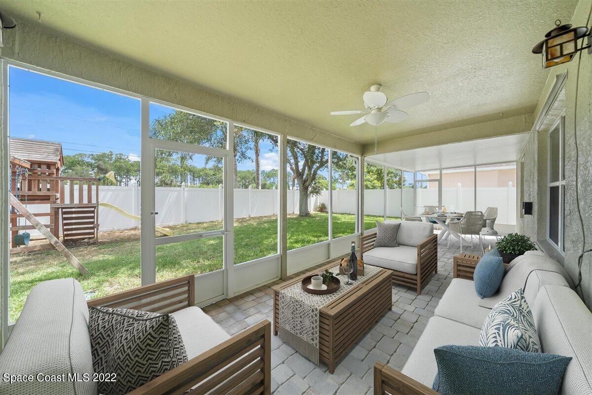 320 Pebble Hill Way Rockledge, FL 32955 - Photo 24 of 27 a living room with furniture and a floor to ceiling window