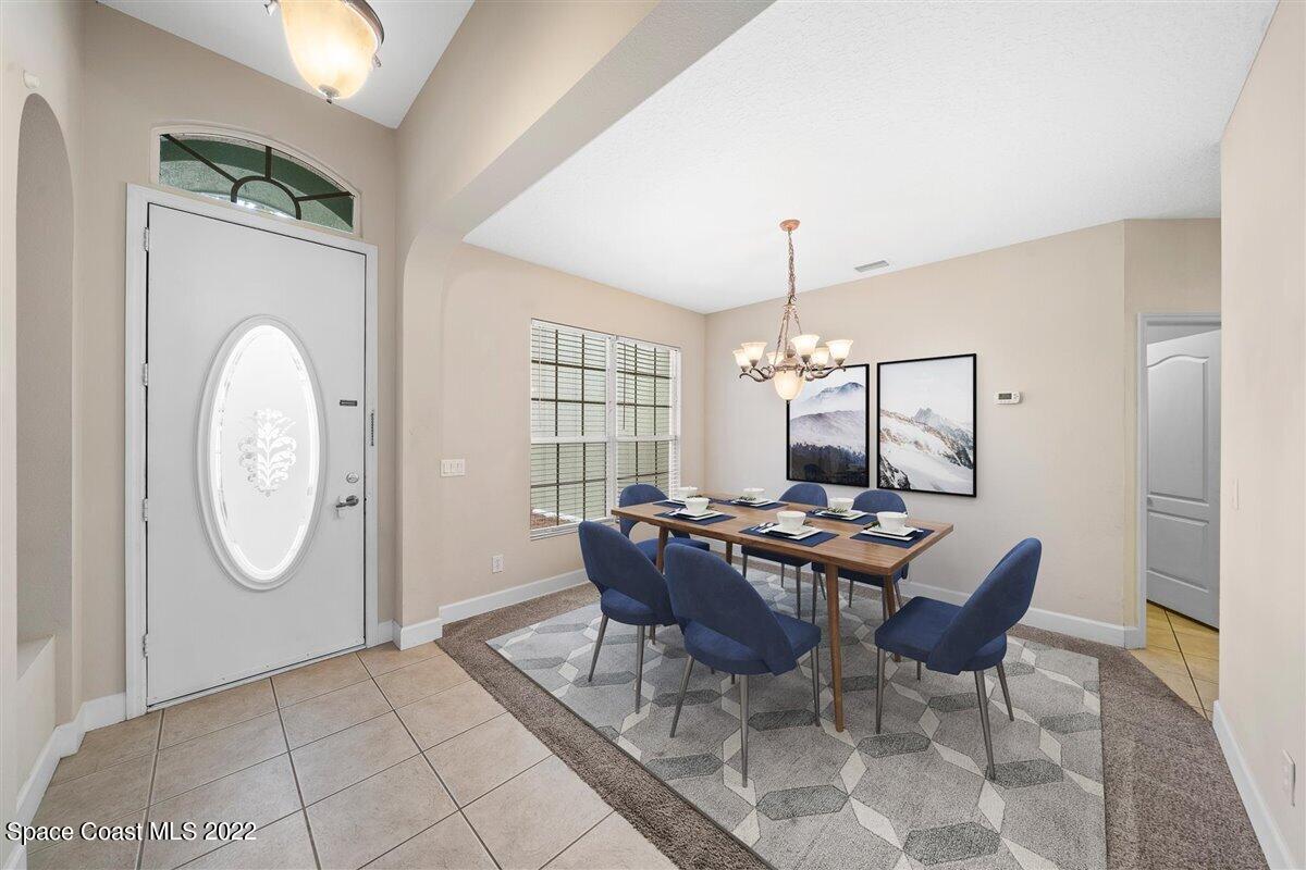 320 Pebble Hill Way Rockledge, FL 32955 - Photo 3 of 27 a dining room with chandelier fan and wooden floor