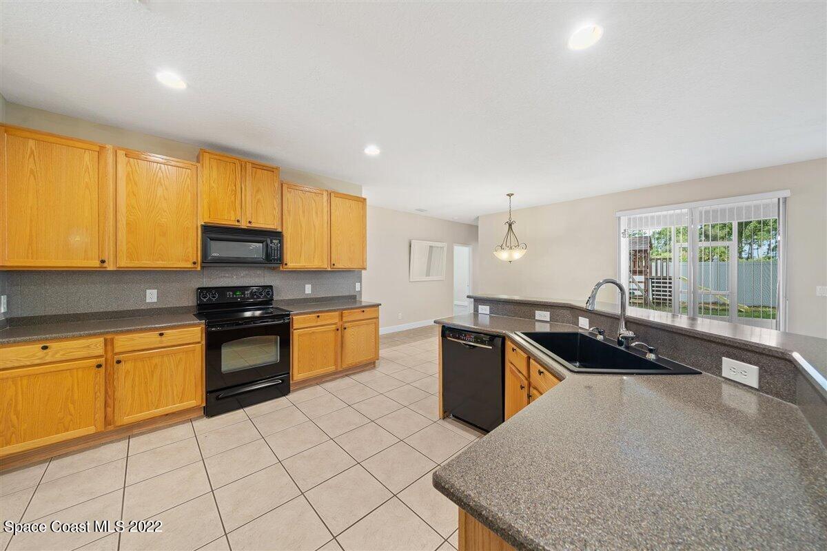 320 Pebble Hill Way Rockledge, FL 32955 - Photo 7 of 27 a kitchen with granite countertop a sink counter top space appliances and cabinets