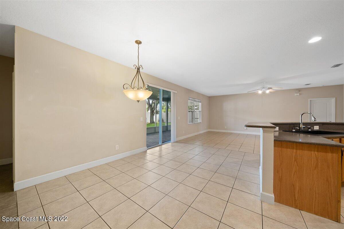320 Pebble Hill Way Rockledge, FL 32955 - Photo 8 of 27 a view of a kitchen with a sink and a refrigerator