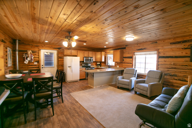 348 North Jakes Pl Road Loa, UT 84747 - Photo 18 of 26 Great room area featuring log walls, wooden ceiling, dark wood-type flooring, recessed lighting, and ceiling fan