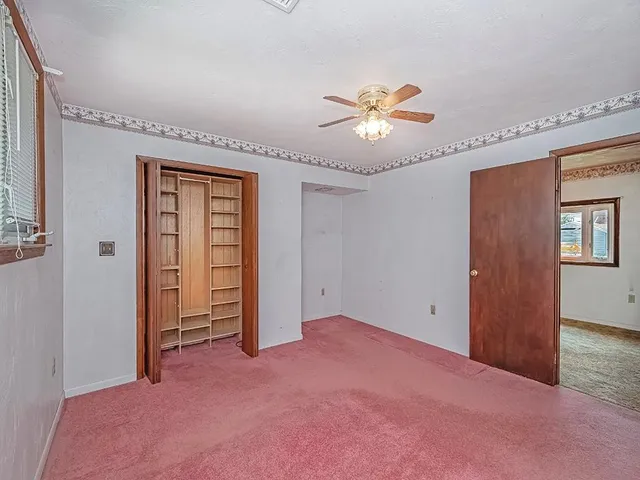 a view of empty room with a fan
