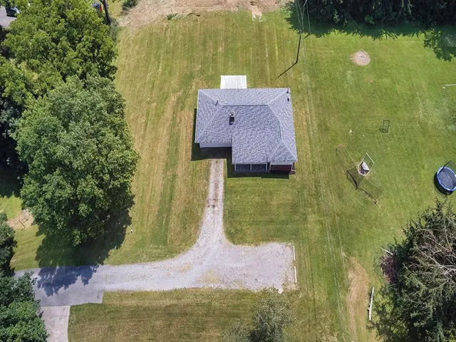 an aerial view of a house with a yard