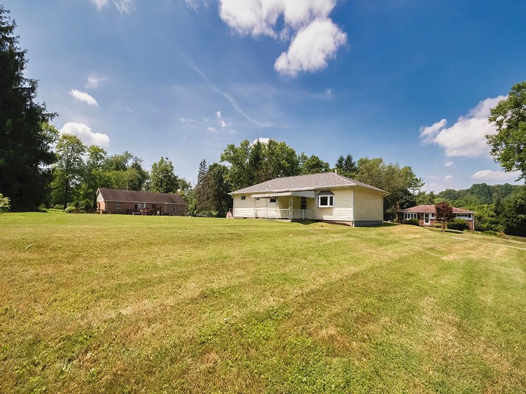 2488 Banks School Road Gibsonia, PA 15044 - Photo 29 of 31 a yellow and red house with a big yard