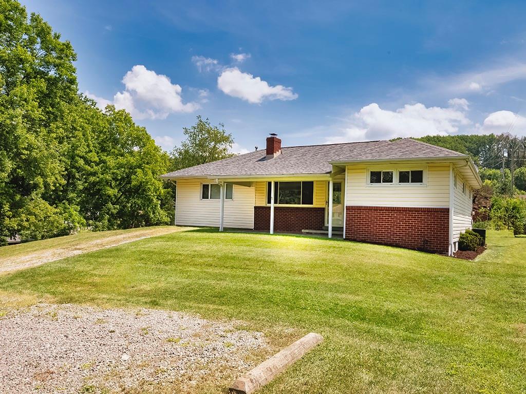 2488 Banks School Road Gibsonia, PA 15044 - Photo 30 of 31 a front view of a house with a garden and yard