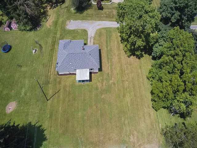 an aerial view of residential house with an outdoor space