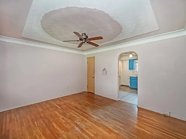 a view of empty room with wooden floor