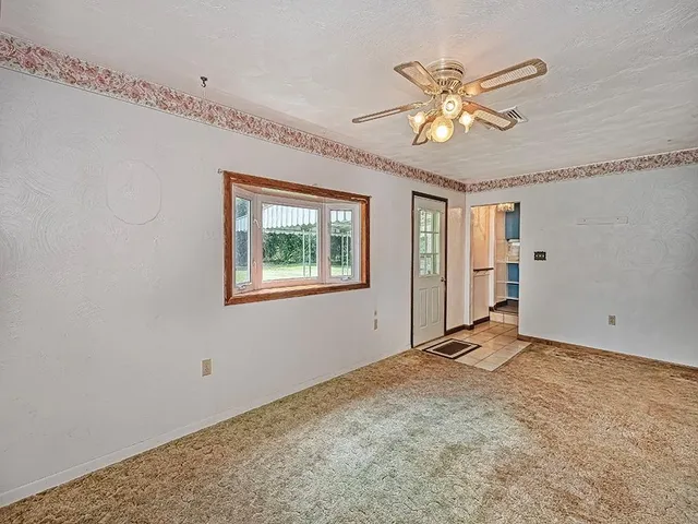 a view of an empty room with a window