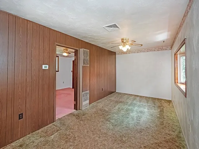 a view of a livingroom with a chandelier fan