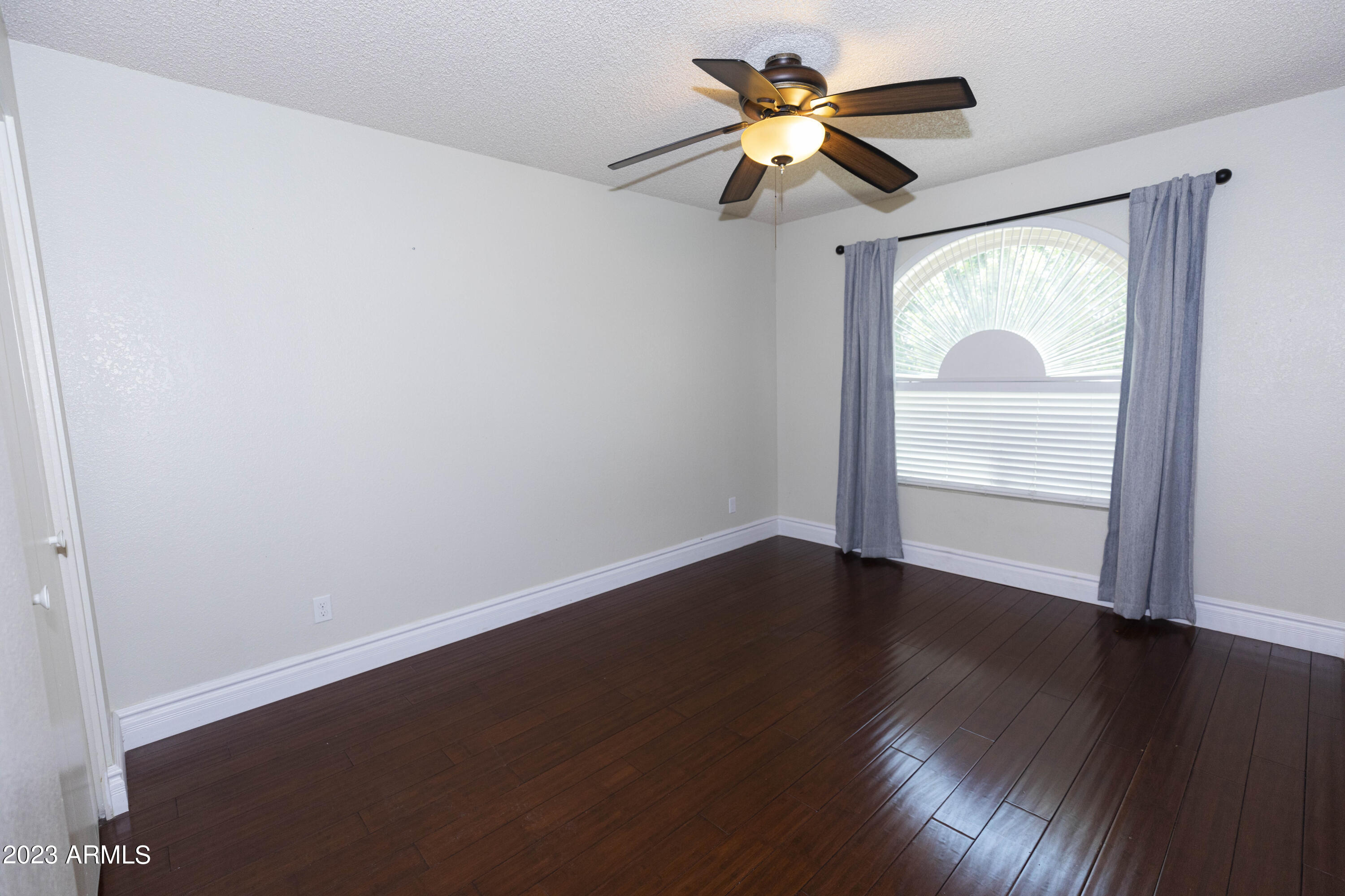 608 East Appaloosa Road Gilbert, AZ 85296 - Photo 17 of 38 wooden floor in an empty room with a window