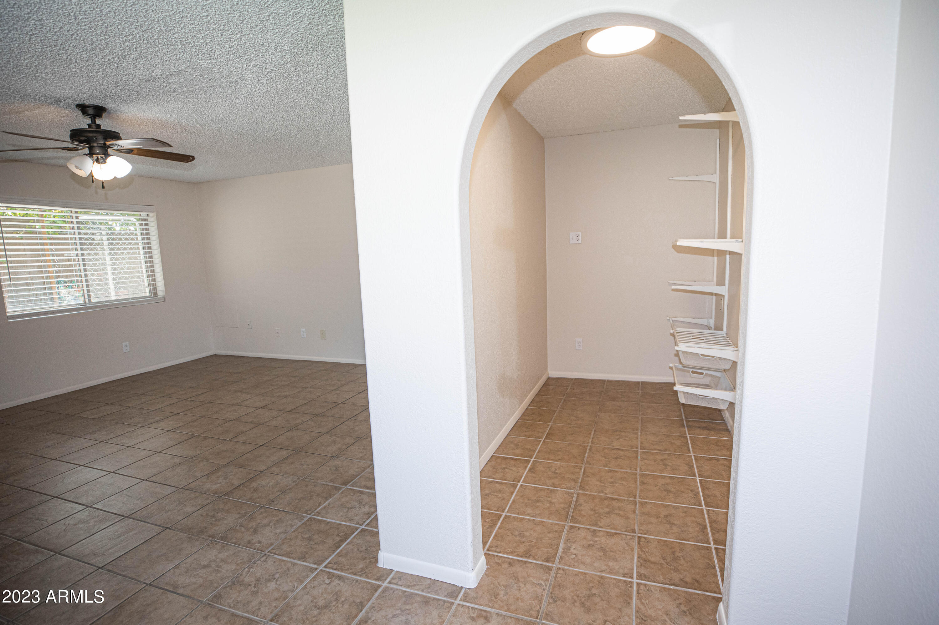 608 East Appaloosa Road Gilbert, AZ 85296 - Photo 25 of 38 an empty room with cabinet and a chandelier fan