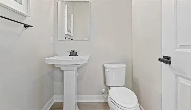 a white toilet sitting next to a bathroom sink