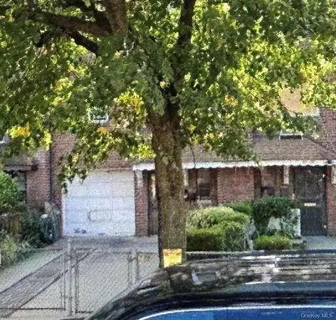 front view of a house with a tree