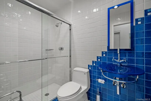 a bathroom with a toilet a sink and shower
