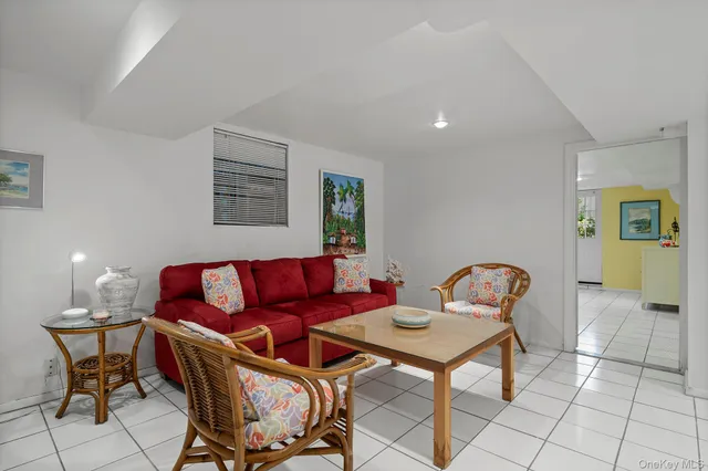 a living room with furniture a rug and a chandelier