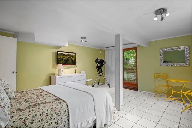 a bedroom with a bed and a flat tv screen