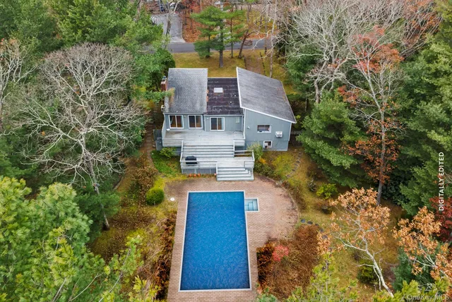 aerial view of a house with a yard