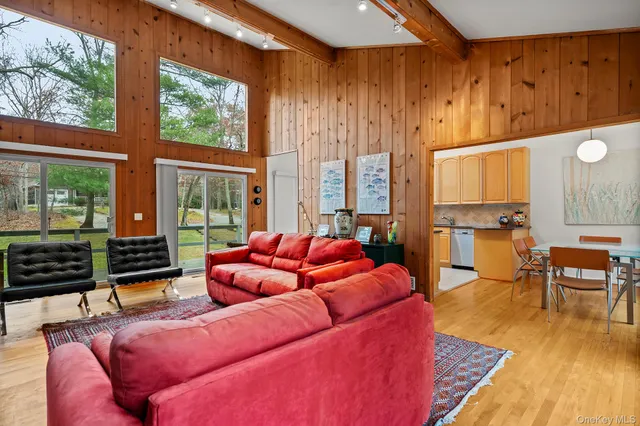 a living room with furniture and large windows