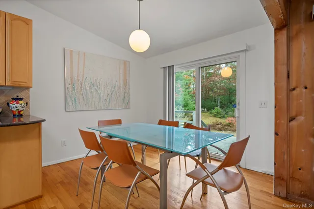 a view of a dining room with furniture and a window