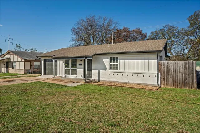 a view of a house with a yard and deck
