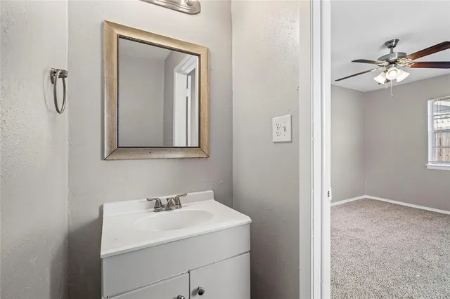 a bathroom with a sink vanity and a mirror