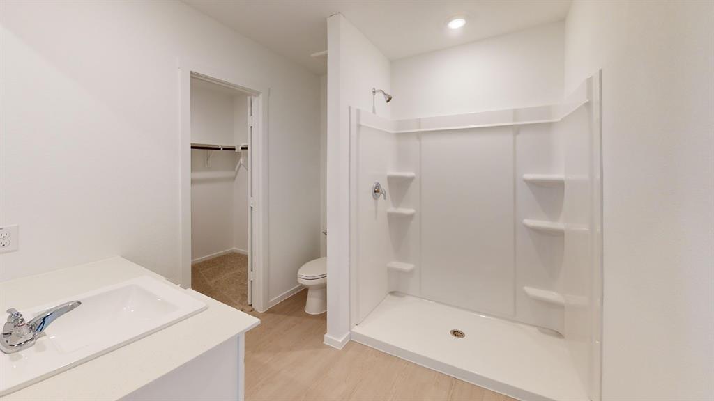 1005 Calley Pear Trail Princeton, TX 75407 - Photo 15 of 20 a bathroom with a shower a toilet and a sink