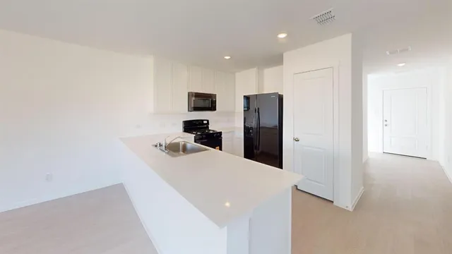 a kitchen with stainless steel appliances a refrigerator and a stove