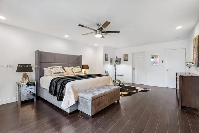 a bedroom with furniture and wooden floor