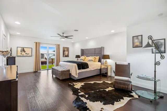 a living room with furniture and wall paintings