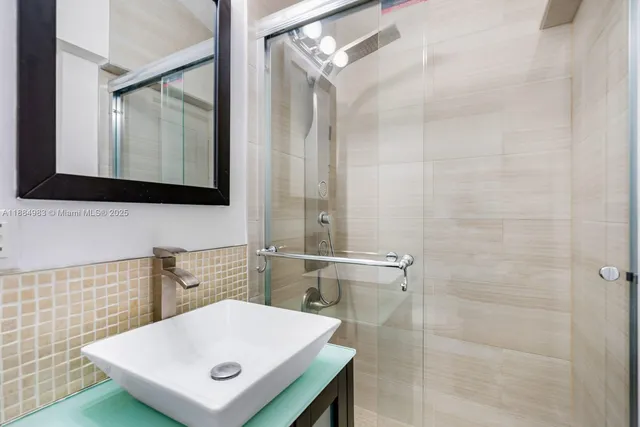 a bathroom with a sink toilet and a mirror