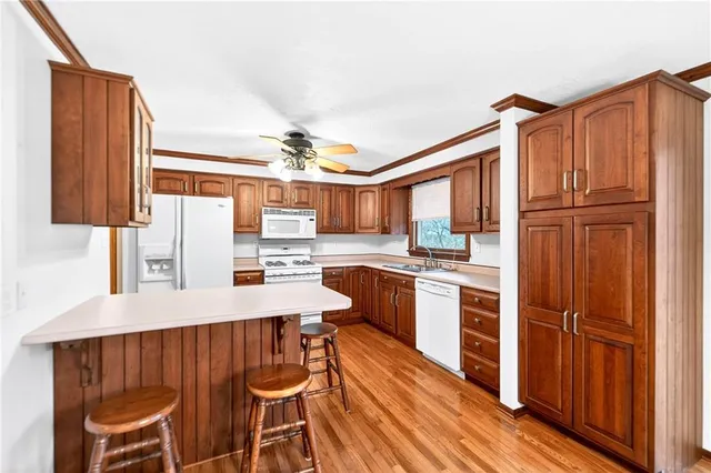 a kitchen with stainless steel appliances a refrigerator and a stove top oven