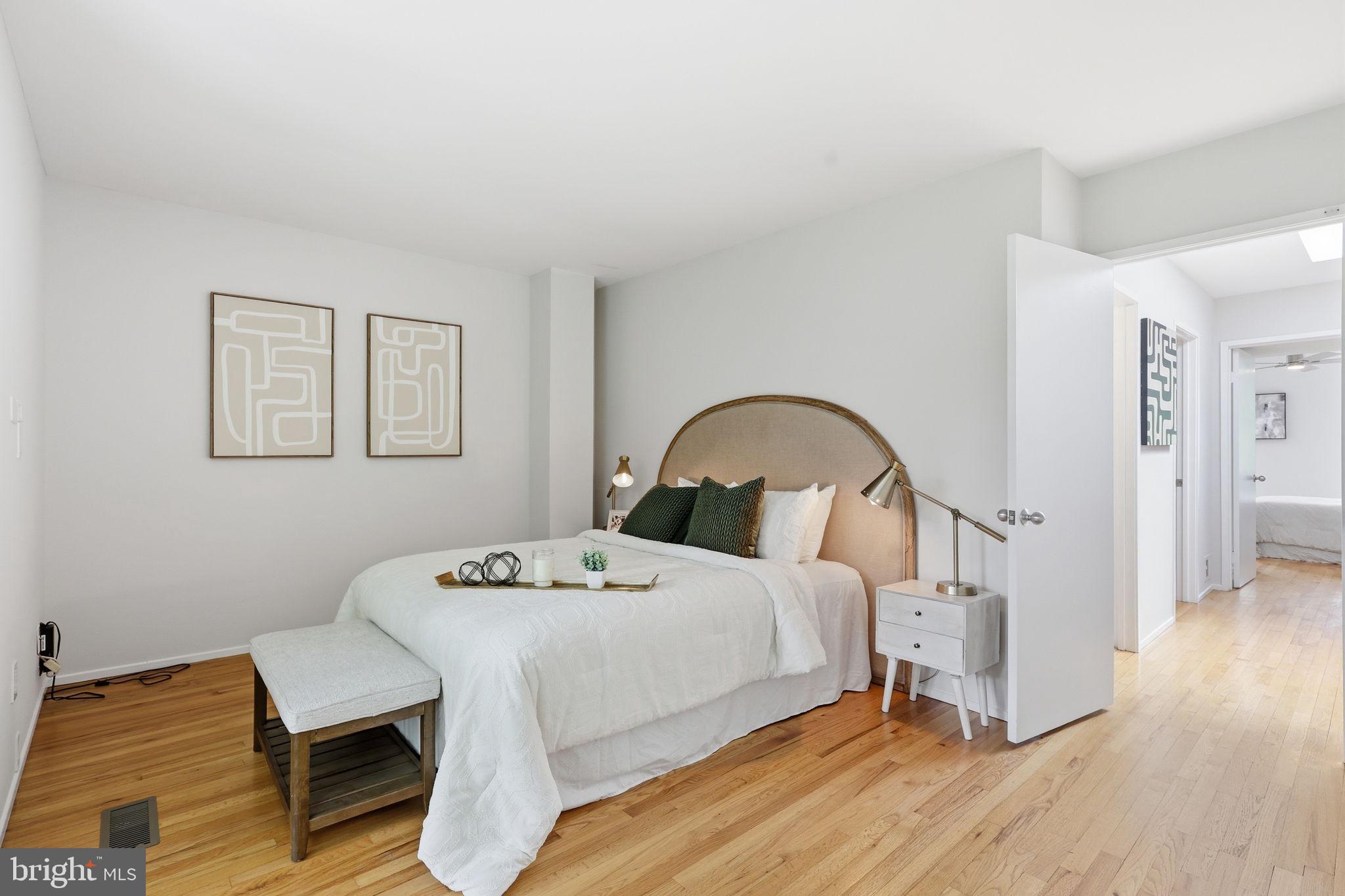 11510 Maple Ridge Road Reston, VA 20190 - Photo 21 of 43 a bedroom with a bed and a table