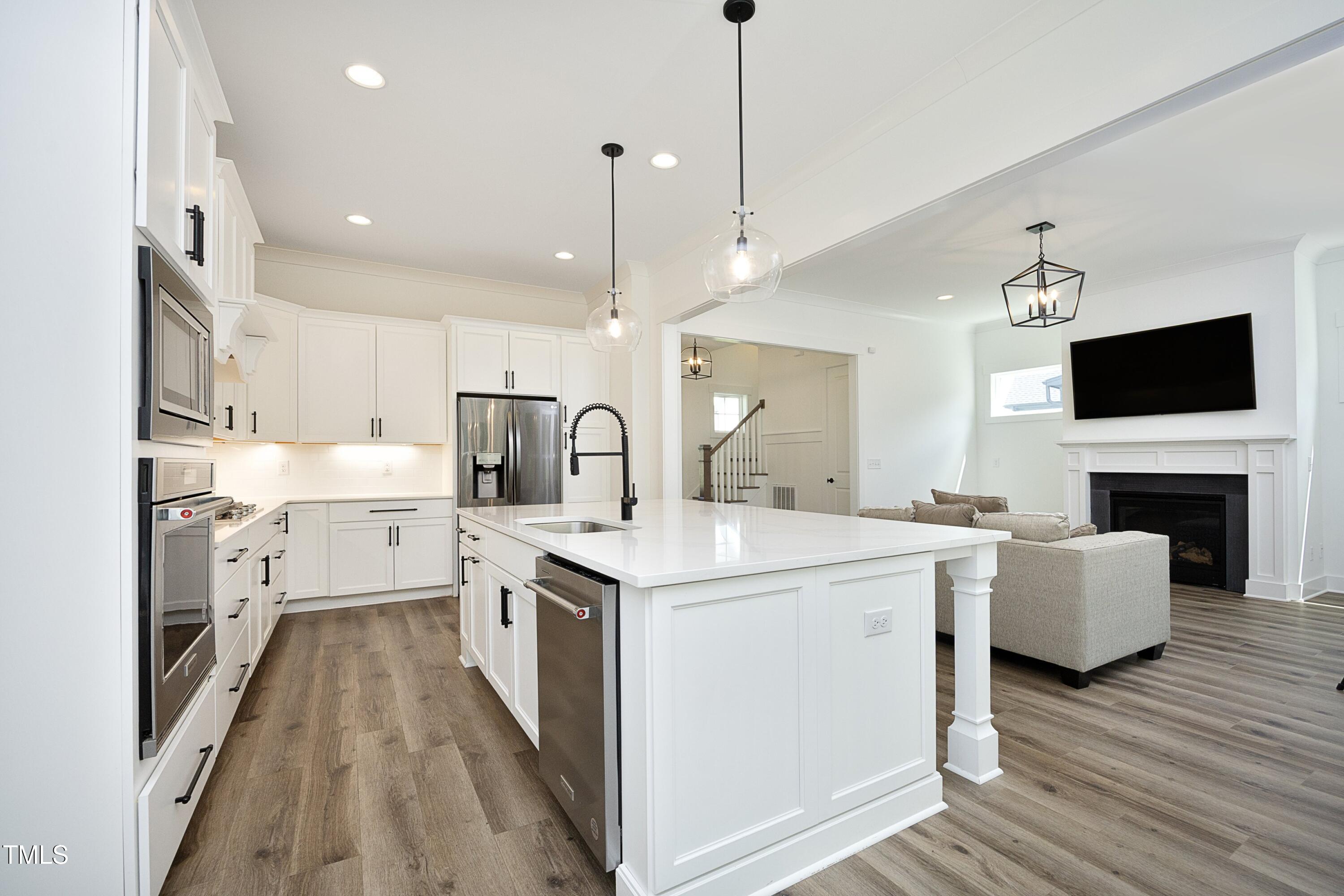 1145 Duke Farm Drive Wake Forest, NC 27587 - Photo 9 of 37 a kitchen with a sink stove and wooden floor