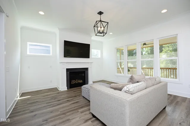 a kitchen with a sink stove and wooden floor