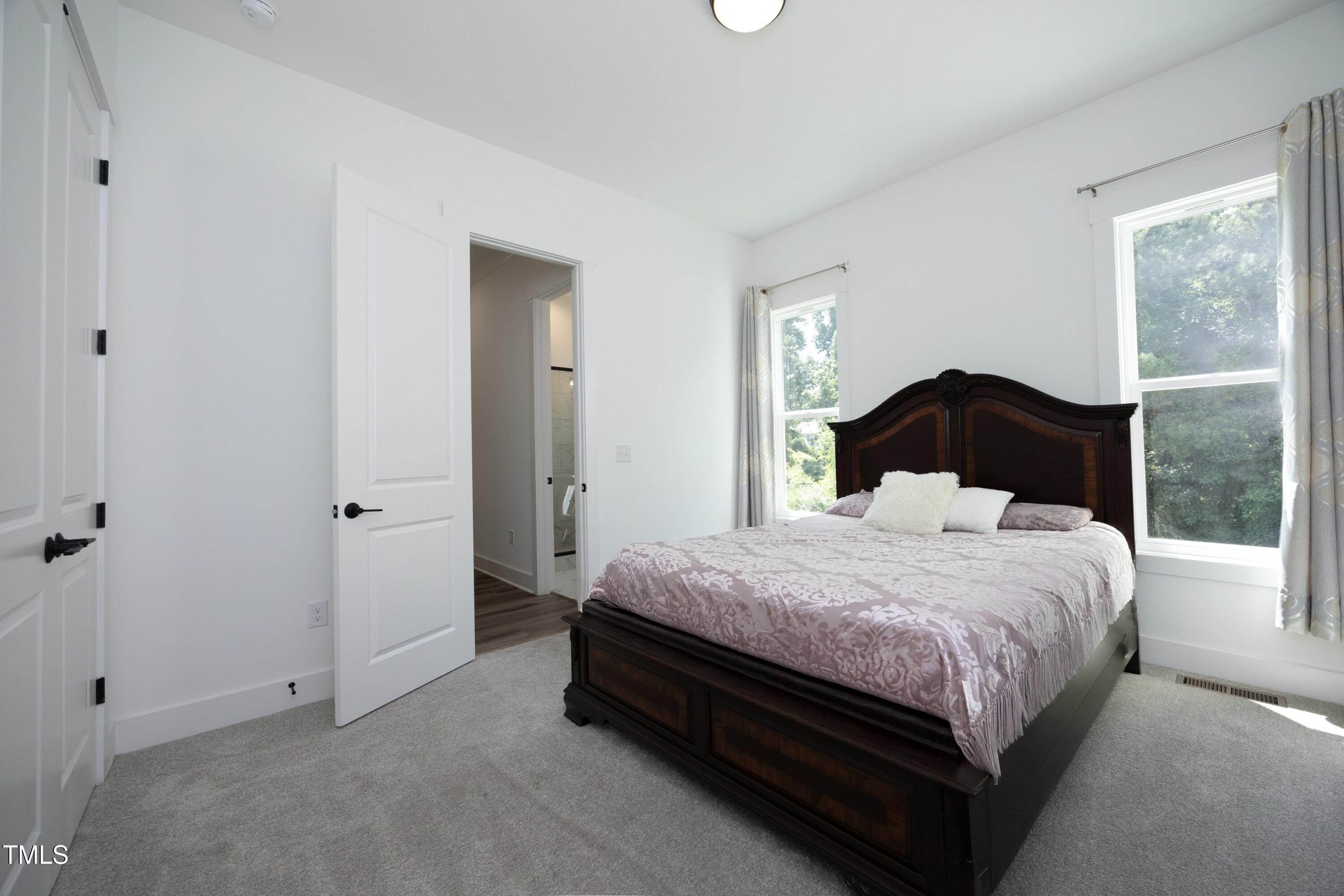 1145 Duke Farm Drive Wake Forest, NC 27587 - Photo 14 of 37 a bedroom with a bed and window