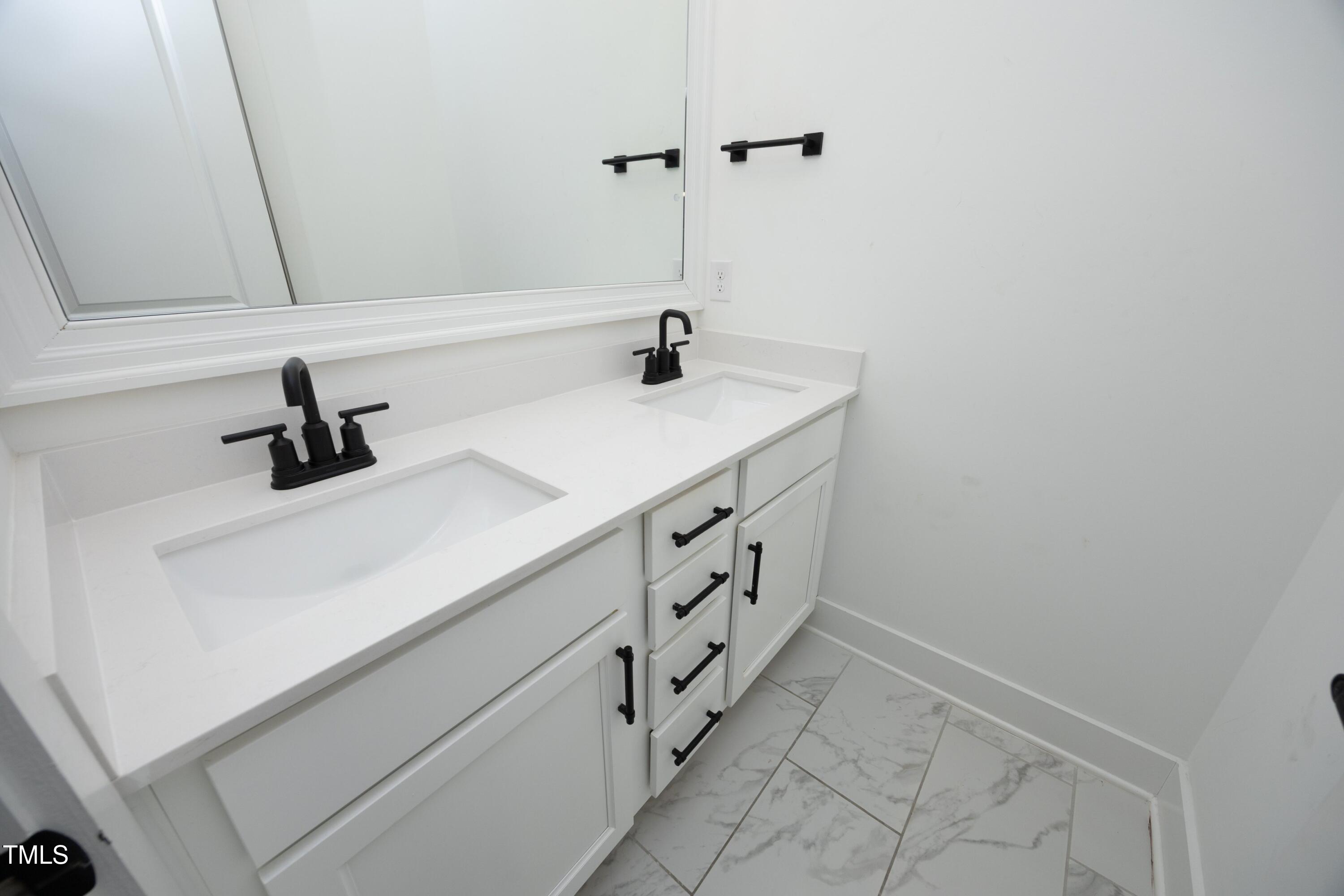 1145 Duke Farm Drive Wake Forest, NC 27587 - Photo 25 of 37 a bathroom with a sink and a mirror