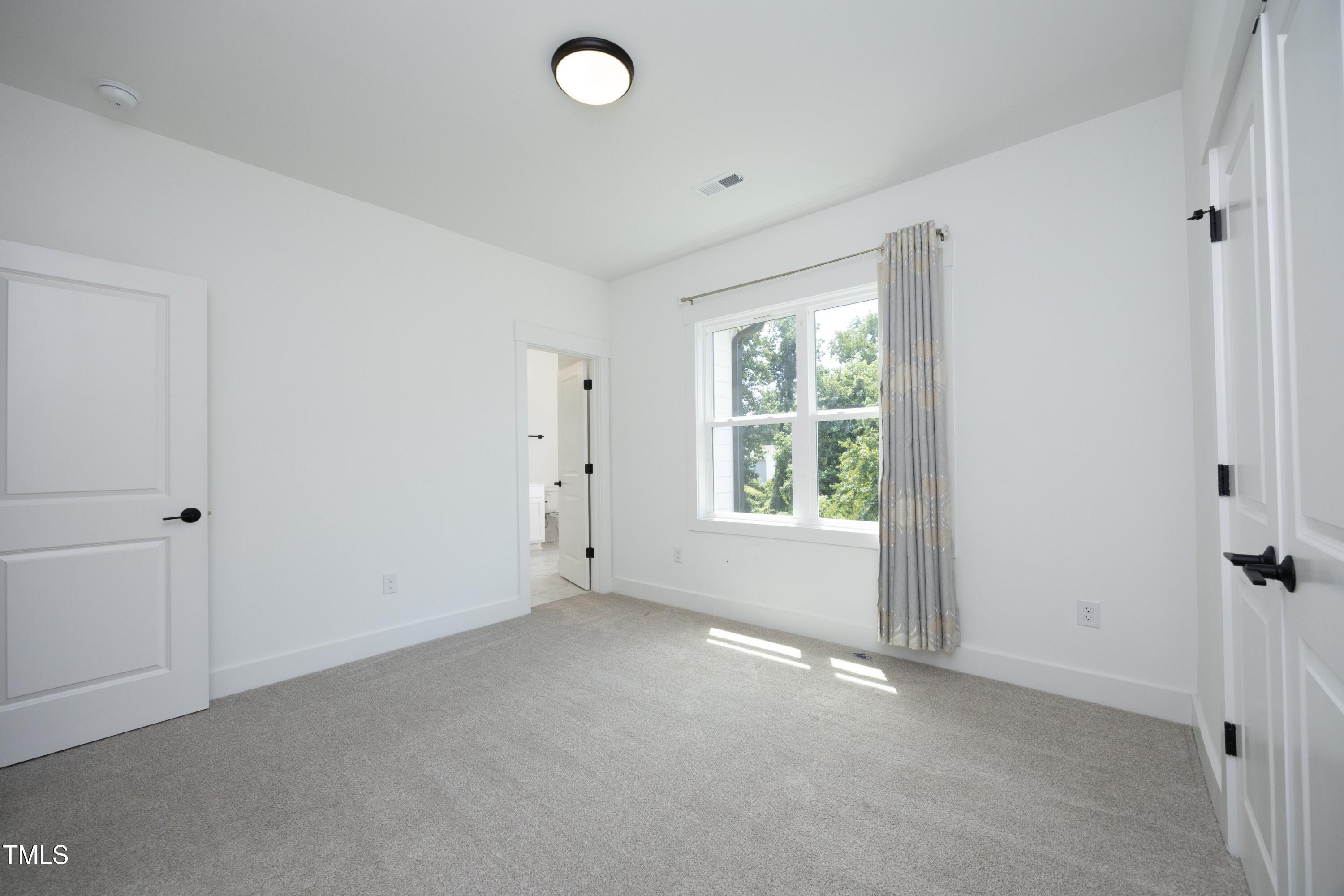 1145 Duke Farm Drive Wake Forest, NC 27587 - Photo 27 of 37 a view of an empty room with a window