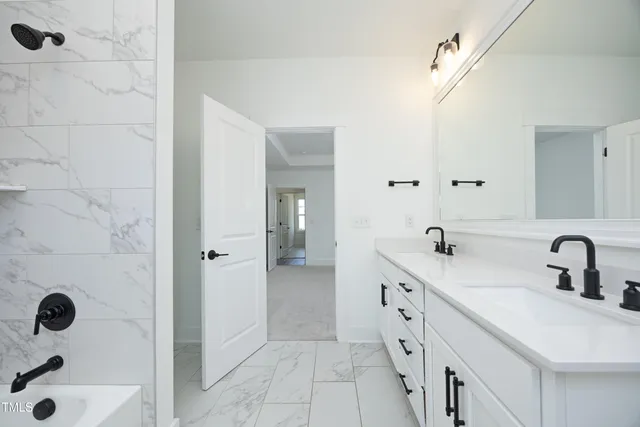 a bathroom with a double vanity sink toilet and a mirror