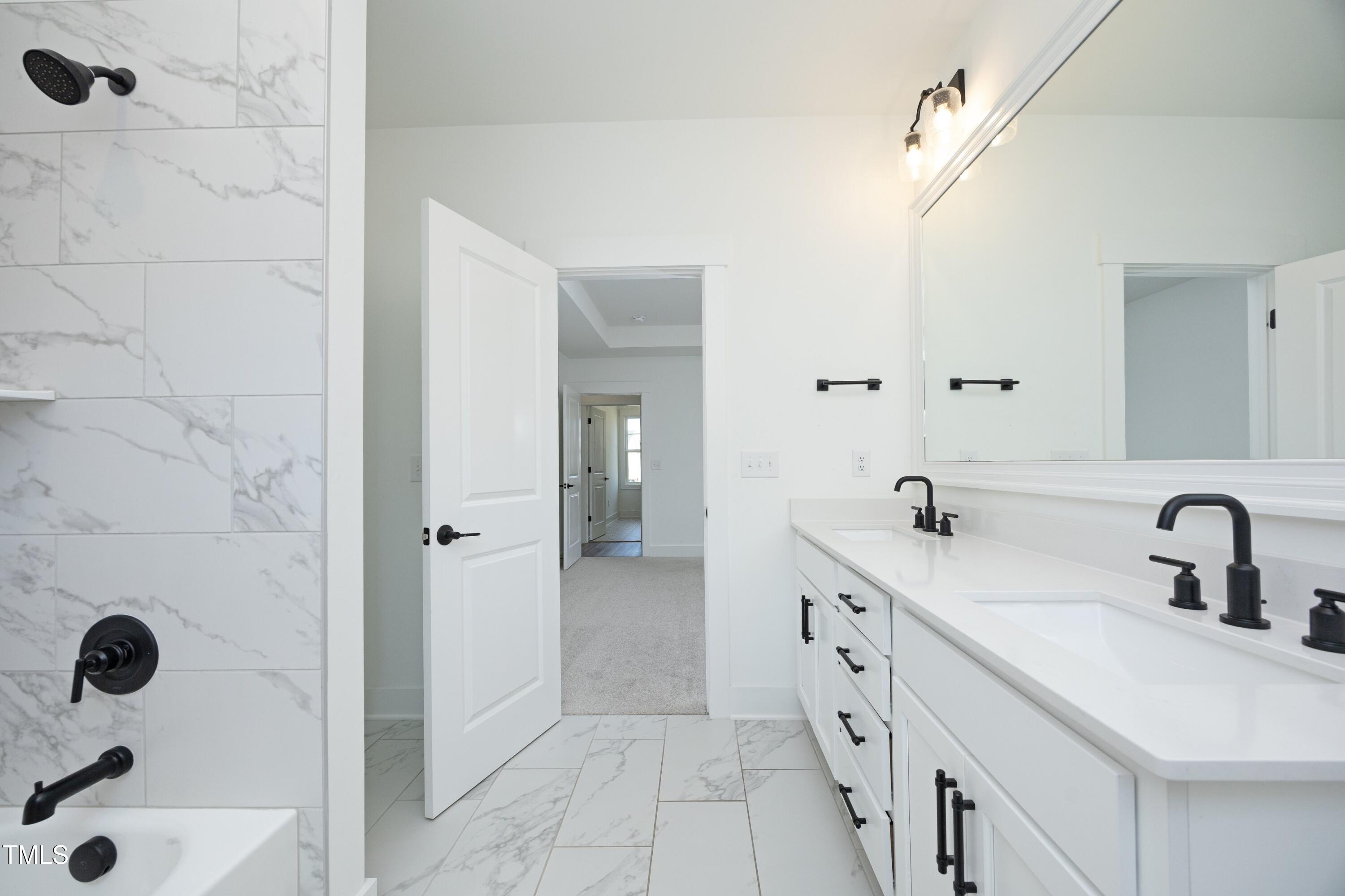 1145 Duke Farm Drive Wake Forest, NC 27587 - Photo 30 of 37 a spacious bathroom with a double vanity sink a mirror and shower