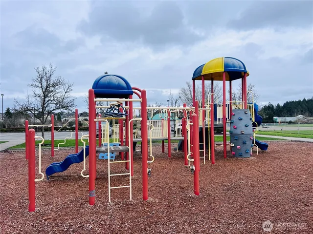 a patio with a table and chairs under an umbrella