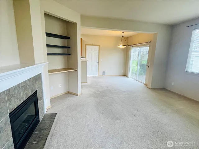 a view of empty room with a fireplace and cabinet