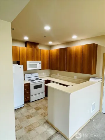 a kitchen with a stove a sink and a refrigerator