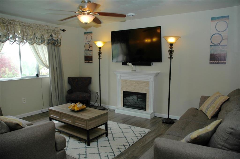 440 West Starz Road Gibsonia, PA 15044 - Photo 3 of 24 Living room with wood floors, fireplace, and huge windows
