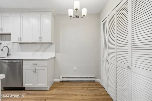 a view of a kitchen with wooden floor