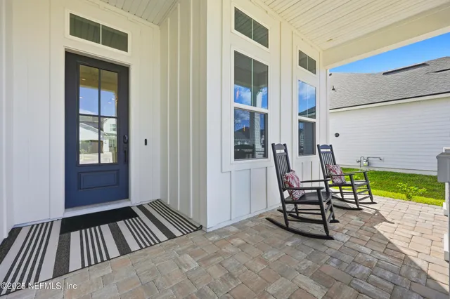 a living room with furniture a bookshelf and a window