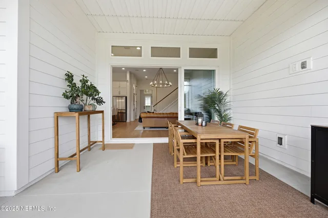 a view of a big house with a big yard and potted plants