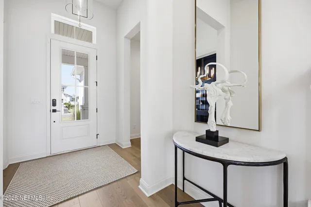a living room with furniture a table and a large window