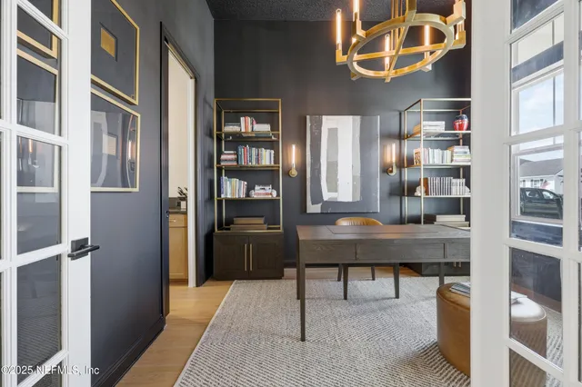 a living room with furniture dining table and a chandelier