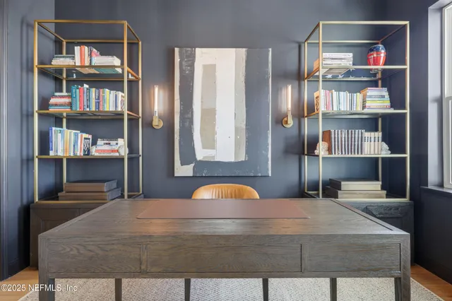 a living room with furniture a fireplace and a floor to ceiling window