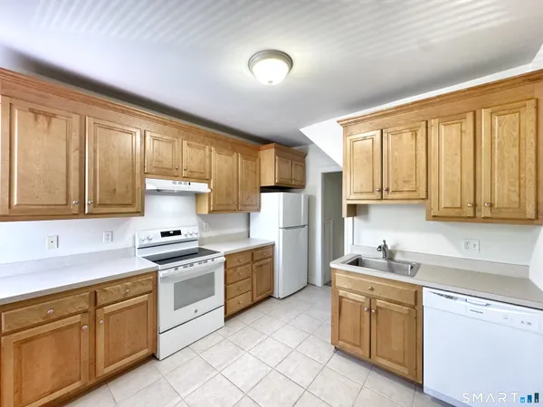a kitchen with a stove a sink and a refrigerator